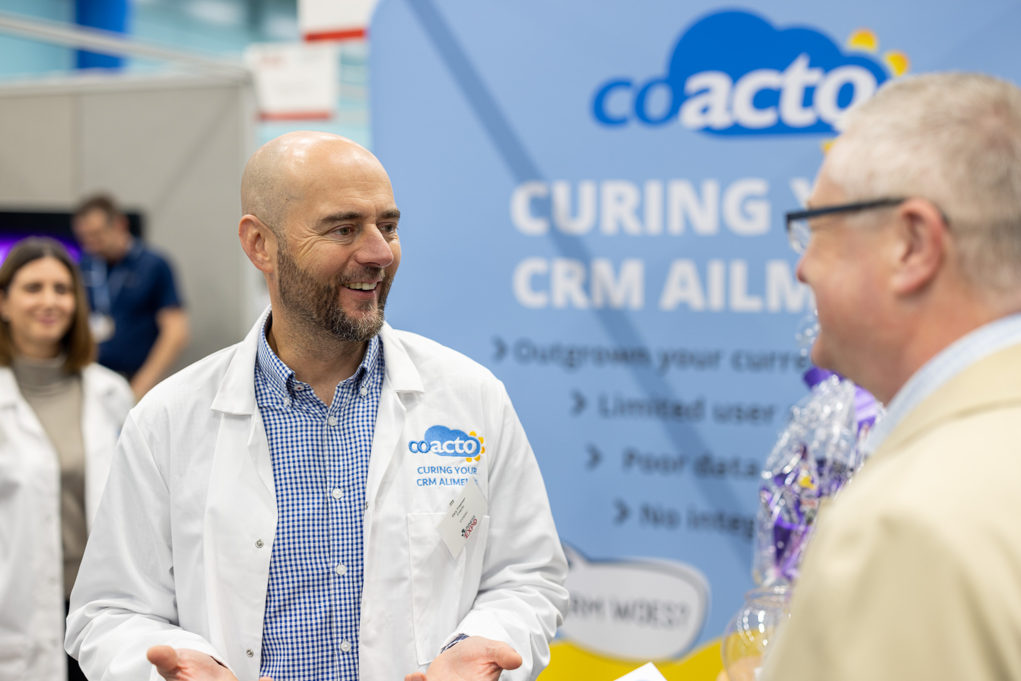two men in building yard with hard hats, shaking hands
