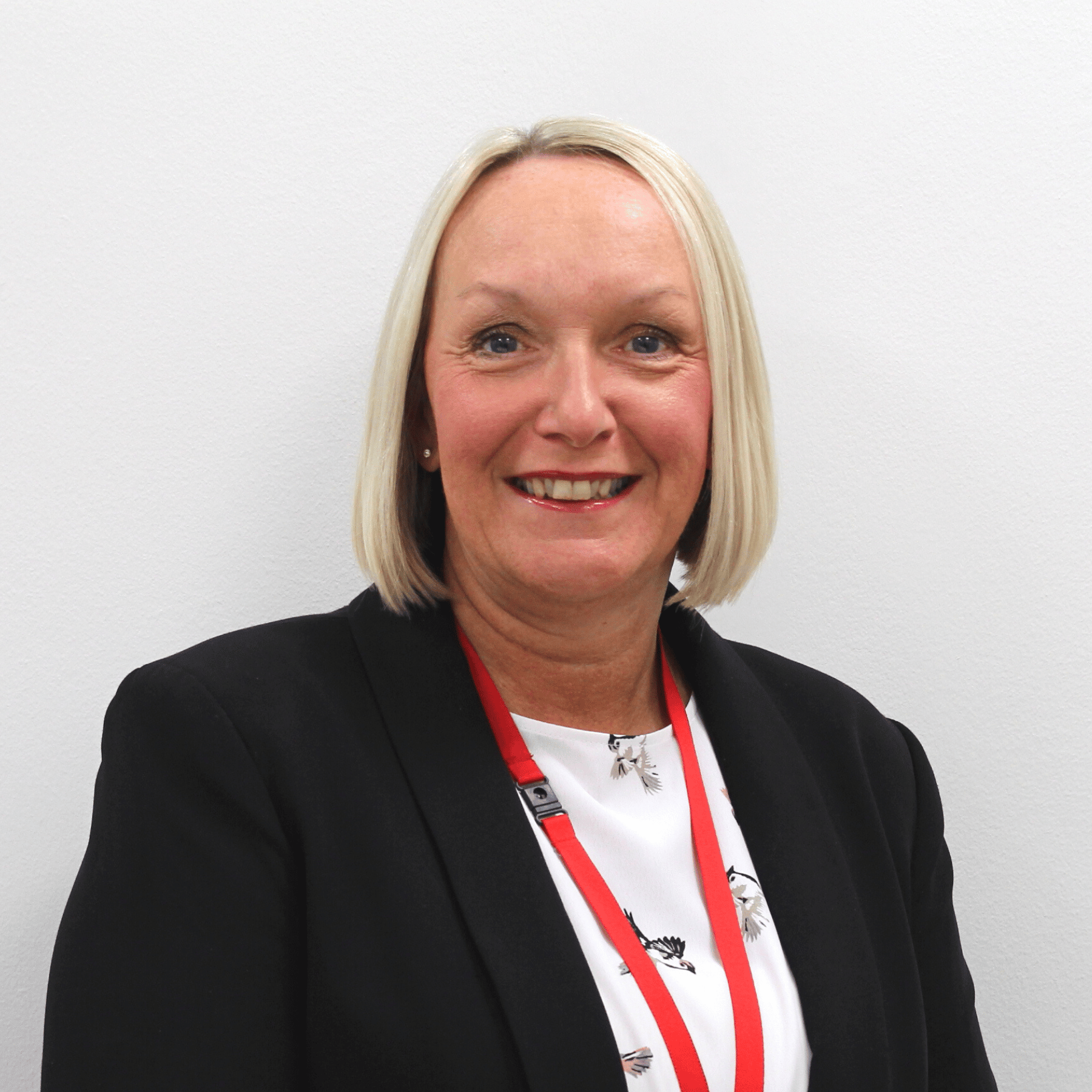 Staff photos (1) two men in building yard with hard hats, shaking hands